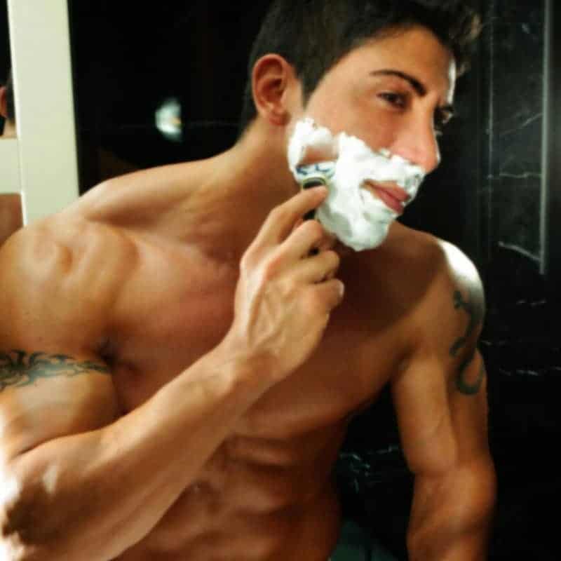 Boy strippers Barcelona in the mirror shaving his face